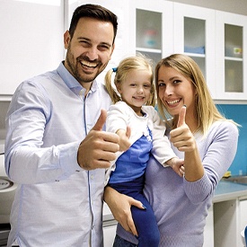 Family smiling together after family dentistry visit