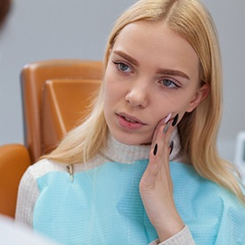 Woman visiting dentist about tooth pain