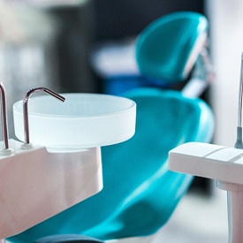 a dental treatment room with dental tools sitting next to a chair